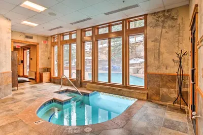 a jacuzzi tub in a room with windows at Ski-Out Keystone Resort Condo with Private Balcony in Keystone