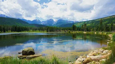 a large lake with mountains in the background at Llama-Stay at Spooky Tooth Ranch - Mtn Views! in Loveland