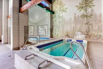 a swimming pool with a hot tub in a house at 2 Bedroom Condo In West Keystone Near Lakeside Village in Keystone