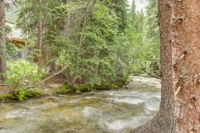 a river in the middle of a forest at Northstar Townhomes In Keystone 2 Bedroom Rental in Keystone