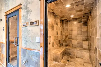 a walk in shower with a glass door at The Timbers In River Run 2 Bedroom Condo in Dillon
