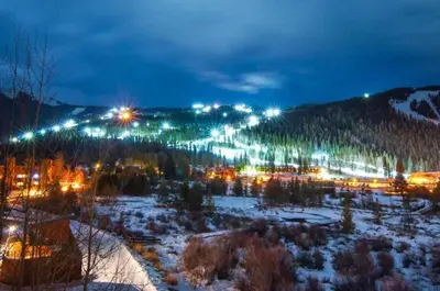a view of a town in the snow at night at Silvermill Lodge 1 Bedroom In River Run Village in Keystone