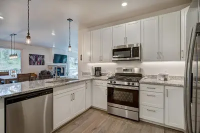 a kitchen with white cabinets and stainless steel appliances at Clearwater Lofts by Vail Resorts in Keystone