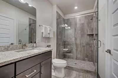 a bathroom with a shower and a toilet and a sink at Clearwater Lofts by Vail Resorts in Keystone