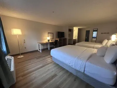 a hotel room with a large bed and a desk at Quality Inn Denver Tech Center in Englewood