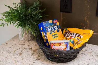 a basket of snacks on a counter with a plant at Sundance-2 miles to Rocky Mountain National Park in Estes Park