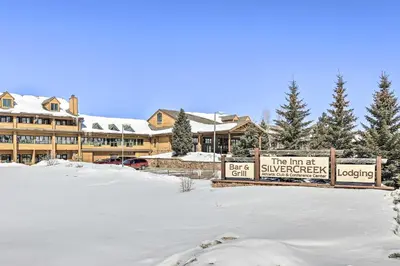 a snow covered parking lot in front of a lodge at Near Skiing Studio with Pool Access in Granby! in Granby
