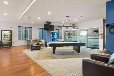 a living room with a pool table in it at Relaxing 3BR Apartment With Pool & Wifi in Greeley