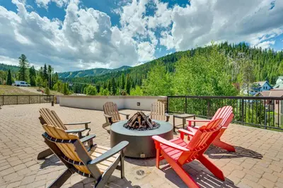 a patio with four chairs and a fire pit at Ski-InandSki-Out Winter Park Condo with Balcony in Winter Park