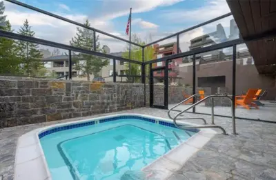 a swimming pool in a house with a building at Snowblaze E102 Studio in Winter Park