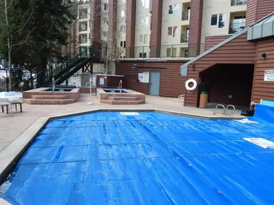 a large blue swimming pool in front of a building at Iron Horse Building J Unit 1309 in Winter Park