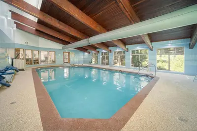 a large indoor swimming pool with a wooden ceiling at Beaver Village Unit #0333 in Winter Park