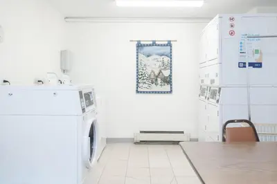 a white laundry room with a washer and dryer at Beaver Village Unit #0333 in Winter Park