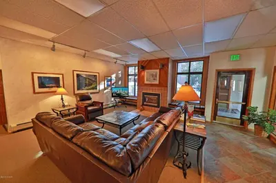 a large living room with a leather couch at Beaver Village Unit #0623R in Winter Park