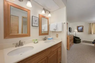 a bathroom with two sinks and a mirror at Beaver Village Unit #0711R in Winter Park