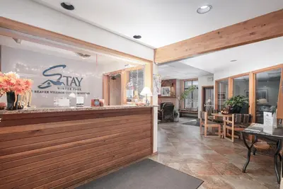 a restaurant with a counter and a dining room at Beaver Village Unit #0711R in Winter Park