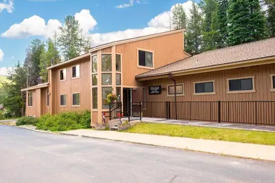 a brown building with a gate and a street at Beaver Village Unit #0711 in Winter Park