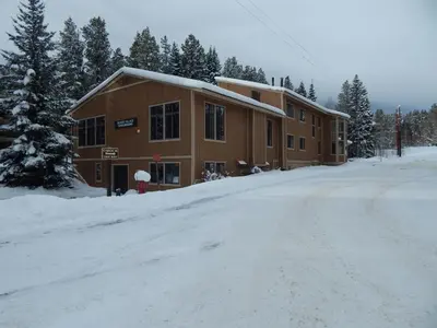 a building on a snow covered road in front at Beaver Village Unit #0514 in Winter Park