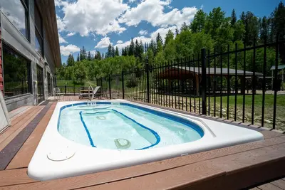 a hot tub on the deck of a house at Hi Country Haus Unit 0309 in Winter Park