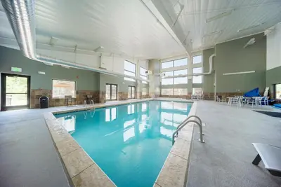 a large swimming pool with blue water in a building at Hi Country Haus Unit 2501 in Winter Park