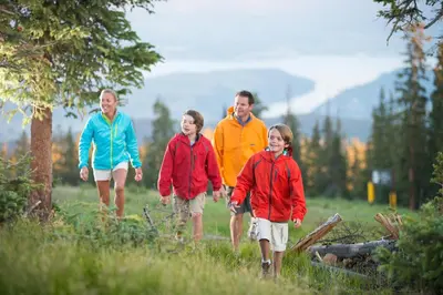 a group of people walking in a field at Premier Silver Mill 8229 - 2Br-Walk to Slopes! Kids Ski Free! condo in Keystone