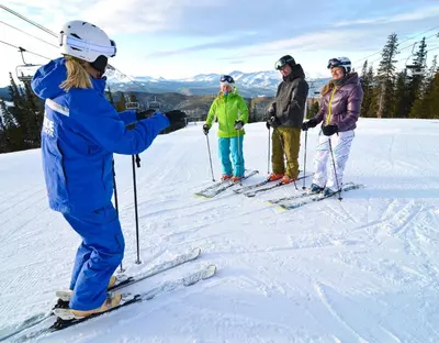 a group of people on skis in the snow at Silver Mill 8260 - 2Br-Walk to Slopes! Kids Ski Free! condo in Keystone