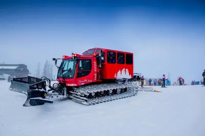 a red snow machine sitting in the snow at Silver Mill 8167 - 1Br-Walk to Slopes! Kids Ski Free! condo in Keystone