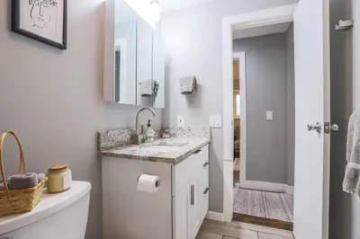 a white bathroom with a sink and a mirror at Large Gorgeous House * Patio w/ Outdoor Dining in Denver