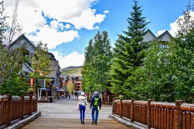 two people walking down a boardwalk in a town at Liftside 104 - Keystone in Keystone