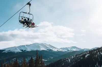 a group of people riding on a ski lift at Windwood Alpine Townhome: Downtown Frisco in Frisco